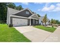 Attractive single-story home with a two-car garage, well-manicured lawn, and inviting curb appeal at 149 Prestwick Way # 39, Mooresville, NC 28115