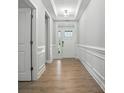 Bright foyer with hardwood floors, elegant trim, and a glimpse of the outdoors at 149 Prestwick Way # 39, Mooresville, NC 28115