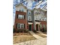 Stylish three-story townhome with brick and siding exterior, complemented by well-maintained landscaping at 16764 Summers Walk Blvd, Davidson, NC 28036