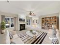 Bright living room featuring a fireplace, large windows, stylish furniture, and a decorative bookshelf at 2683 Beulah Church Rd, Matthews, NC 28104