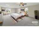 Serene main bedroom with neutral tones, large windows, stylish furniture, and ample natural light at 2683 Beulah Church Rd, Matthews, NC 28104