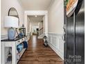 Inviting foyer with hardwood floors, wainscoting, and an elegant console table at 3193 Burnello Ct, Iron Station, NC 28080