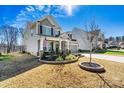Two-story home with a well-manicured lawn, American flag, and covered front porch at 3193 Burnello Ct, Iron Station, NC 28080