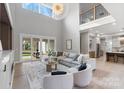 Bright and airy living room with soaring ceilings, contemporary decor, and seamless indoor-outdoor flow at 400 Canvasback Rd, Mooresville, NC 28117