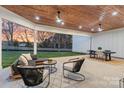Inviting covered patio area with modern furniture, ceiling fans and view of the backyard at 400 Canvasback Rd, Mooresville, NC 28117