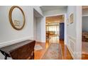 Inviting foyer with hardwood floors, elegant wainscoting, and views into the living area at 41108 Calla Lily St, Fort Mill, SC 29707