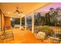 Enjoy the spacious brick back porch with ceiling fan, perfect for relaxing and enjoying the outdoors at 4421 Windwood Cir, Charlotte, NC 28226