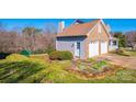 A well-maintained home with an attached two-car garage and a landscaped yard with blooming flowers at 538 30Th Avenue Ne Cir, Hickory, NC 28601