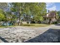 Spacious backyard featuring a basketball court and seating, perfect for outdoor activities and entertaining at 642 W Front St, Statesville, NC 28677
