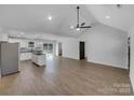 Spacious living room and kitchen area with vaulted ceiling, wood floors and ample natural light at 733 Baker St, Kannapolis, NC 28081