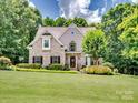 Charming brick home with a well-manicured lawn and mature trees, creating a welcoming curb appeal at 821 Lynnwood Farms Dr, Fort Mill, SC 29715
