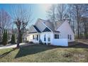 Well-maintained home with manicured lawn, inviting front porch, and charming architectural details at 8421 Kings Creek Dr, Charlotte, NC 28273