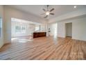 Open-concept living room flows into a modern kitchen with bright white walls and wood flooring at 0000 Trull Hinson Rd # 1, Wingate, NC 28174