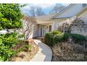 Inviting front entrance with a well-manicured walkway and blossoming plants at 10829 Carmody Ct, Charlotte, NC 28277