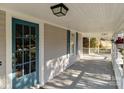Spacious covered front porch with teal door and ample room for seating and relaxation at 1135 Old Charlotte Rd, Concord, NC 28027
