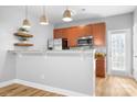 Well-equipped kitchen featuring stainless steel appliances, granite countertops, and modern lighting fixtures at 12417 Mcgrath Dr, Charlotte, NC 28269
