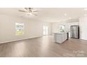 Open concept living room with views of the kitchen and outdoor living space at 125 Lightning Dr, Shelby, NC 28152