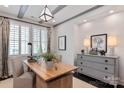 Bright home office with a wooden desk, comfortable chairs, and stylish decor at 13217 Oak Farm Ln, Huntersville, NC 28078