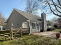 Back of home featuring a brick patio, gray siding and large windows for ample natural light at 1347 Eisenhower Nw Pl, Concord, NC 28027