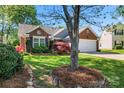 Charming one-story home featuring brick and siding with a two-car garage and attractive landscaping at 1347 Eisenhower Nw Pl, Concord, NC 28027