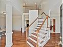 Bright foyer boasts a grand staircase, hardwood floors, and views of the living spaces at 1525 Autumn Brook Ln # 78, Clover, SC 29745