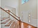 Bright entryway boasts hardwood floors, staircase, and natural light from sidelight windows at 1525 Autumn Brook Ln # 78, Clover, SC 29745
