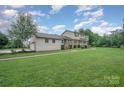 Beautiful home featuring neutral siding, an expansive lawn, and mature trees at 16308 Poplar Tent Rd, Huntersville, NC 28078