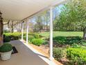 Spacious covered front porch with white columns, brick trim, and views of the landscaped yard at 17109 Cabarrus Rd, Midland, NC 28107