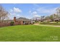 Classic brick home with a lush green lawn and winding driveway at 1921 Wexford Ct, Gastonia, NC 28054