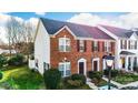Charming brick townhome featuring a well-manicured lawn and inviting entryway, ideal for comfortable living at 1965 Charlotte Hwy # 401, Mooresville, NC 28115