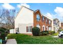 An end unit townhome with brick and vinyl siding and well-maintained landscaping at 1965 Charlotte Hwy # 401, Mooresville, NC 28115