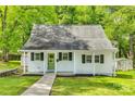 Charming home with a well-manicured lawn, covered front porch and a green front door at 210 Knox St, Clover, SC 29710