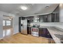 Modern kitchen with stainless steel appliances, dark cabinets, and granite countertops at 210 Knox St, Clover, SC 29710