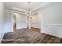 Bright dining area with decorative columns, wainscoting, and modern chandelier at 2252 Tabor Rd # 575, Sherrills Ford, NC 28673