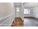 Inviting hallway featuring decorative wainscoting and stylish wood-look flooring leading to a brightly lit room at 2252 Tabor Rd # 575, Sherrills Ford, NC 28673
