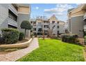 Beautifully landscaped courtyard with walking path between condo buildings at 226 Queens Rd # 73, Charlotte, NC 28204
