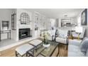 Bright living room with fireplace, white built-in shelves and modern furniture at 226 Queens Rd # 73, Charlotte, NC 28204