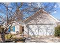 Charming home featuring a two-car garage, neutral siding, manicured lawn and inviting front entrance at 228 Grayland Rd, Mooresville, NC 28115