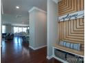 Foyer with wood floors and decorative storage leading into an open-concept living space with dining and kitchen areas at 246 Sweet Briar Dr, Fort Mill, SC 29707