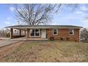 Well-maintained brick ranch home with a covered parking area and a lovely front yard at 2500 Belshire Dr, Conover, NC 28613