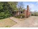 Charming single-story brick home featuring a well-manicured lawn and a concrete driveway at 2922 Dunlavin Way, Charlotte, NC 28205