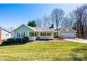 Inviting home features a classic covered porch, neat landscaping, and a well-maintained lawn at 3863 Shakespeare Dr, Hickory, NC 28601