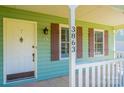 Close-up of the front door with sidelight windows and decorative shutters at 3863 Shakespeare Dr, Hickory, NC 28601