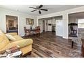 Cozy living room featuring hardwood floors, a ceiling fan, and seamlessly connects to the kitchen and bedroom at 464 Willetta Nw Pl, Concord, NC 28027