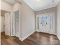 Bright entryway featuring wood flooring, white trim, and a glass-paneled front door with side lights at 5013 Watercrest Trl, Belmont, NC 28012