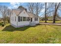 Quaint one-story home featuring white siding, black shutters, and a spacious front yard at 502 Crawford St, Shelby, NC 28150