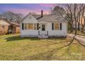 Charming one-story home with white siding, black shutters, and a well-maintained lawn at 502 Crawford St, Shelby, NC 28150