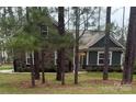 Charming home featuring stone and siding, complemented by lush greenery and a well-maintained lawn at 506 Muirfield Way, Salisbury, NC 28144