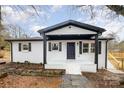 Charming home with black and white accents, a cozy front porch, and inviting curb appeal at 5674 Alan D Good Ln, Conover, NC 28613