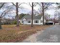 A quaint home with mature trees, a private driveway, and a spacious yard at 609 Eddleman Rd, Kannapolis, NC 28083